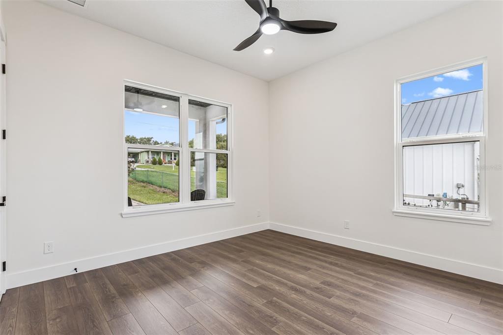 17540 3rd Street Montverde, FL 34756 - Photo 12 of 80 an empty room with wooden floor fan and windows