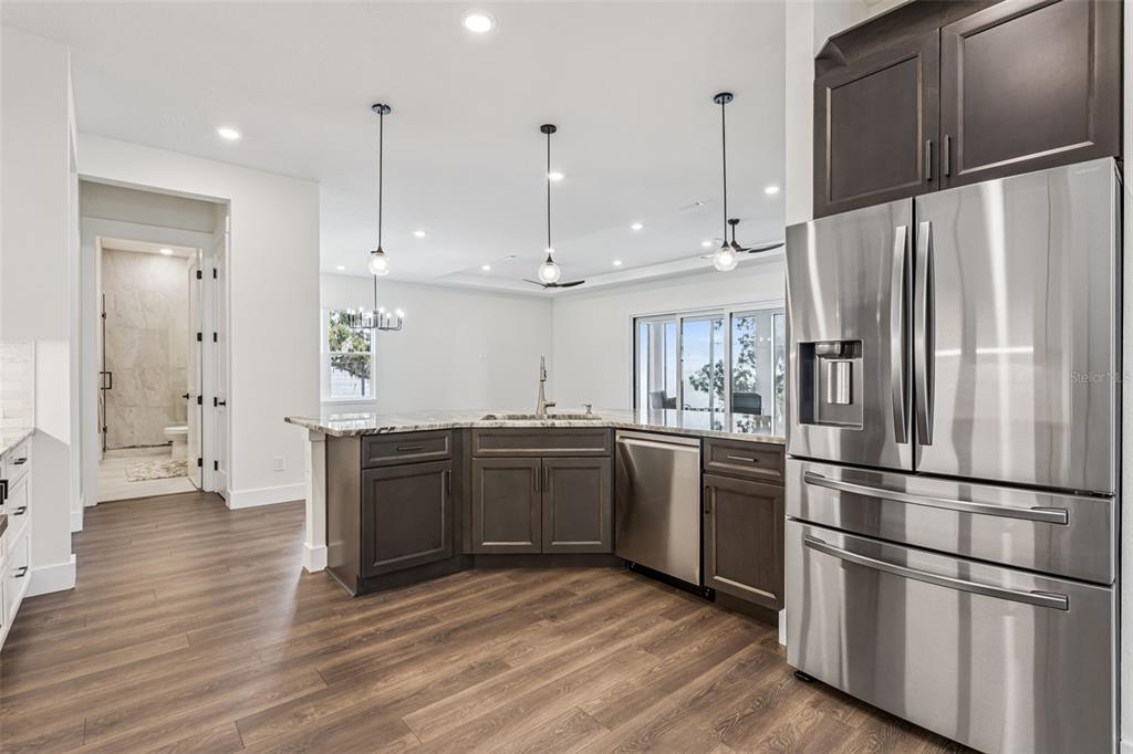 17540 3rd Street Montverde, FL 34756 - Photo 14 of 80 a kitchen with stainless steel appliances granite countertop a refrigerator microwave and white cabinets