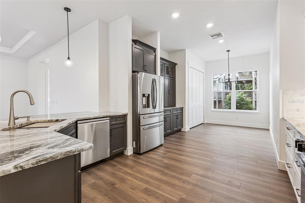 17540 3rd Street Montverde, FL 34756 - Photo 16 of 80 a kitchen with stainless steel appliances granite countertop a refrigerator and a stove top oven