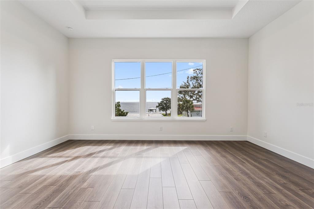 17540 3rd Street Montverde, FL 34756 - Photo 27 of 80 an empty room with wooden floor and windows