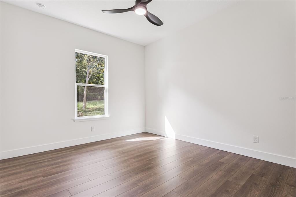 17540 3rd Street Montverde, FL 34756 - Photo 30 of 80 an empty room with wooden floor and windows