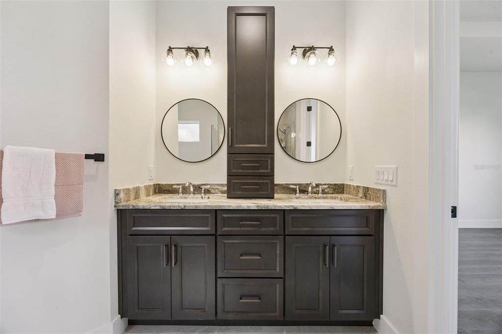 17540 3rd Street Montverde, FL 34756 - Photo 33 of 80 a bathroom with a double vanity sink and a mirror