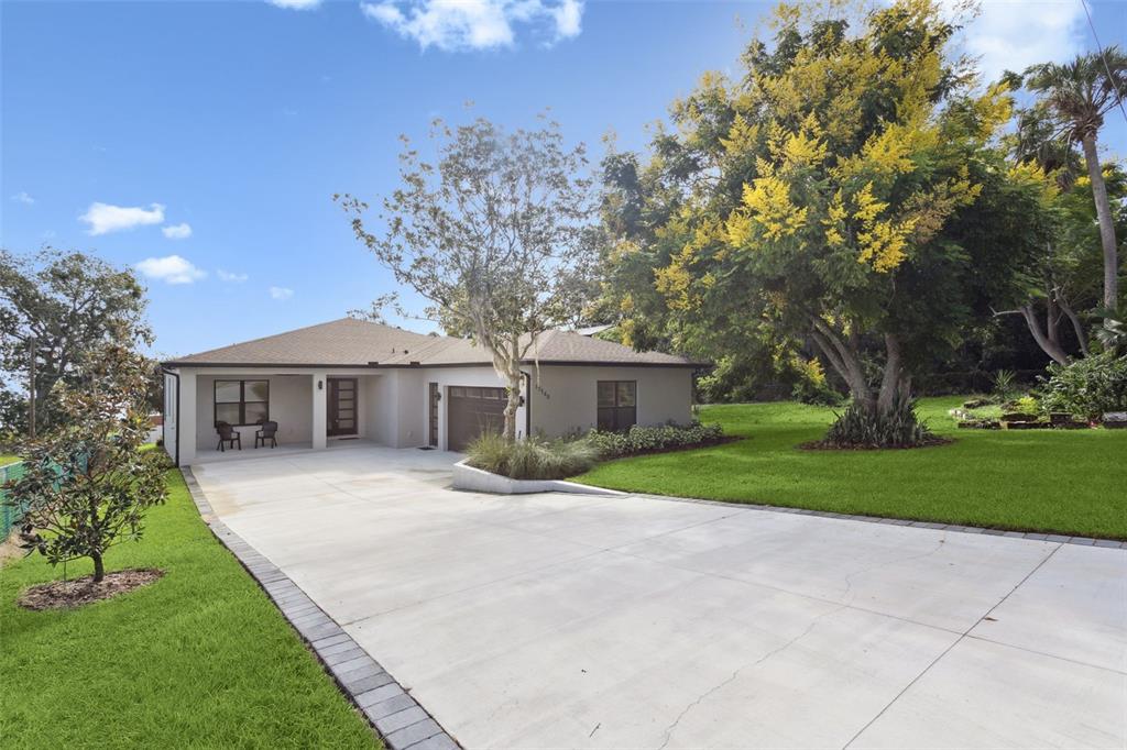 17540 3rd Street Montverde, FL 34756 - Photo 8 of 80 a front view of a house with garden
