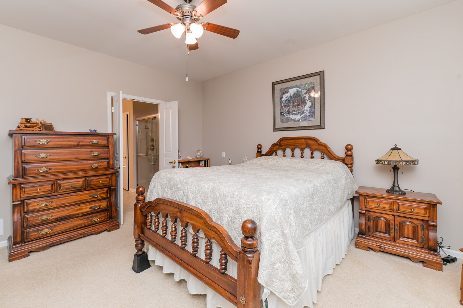 13822 Chestnut Lane Huntley, IL 60142 - Photo 18 of 43 a bedroom with a bed and a chandelier