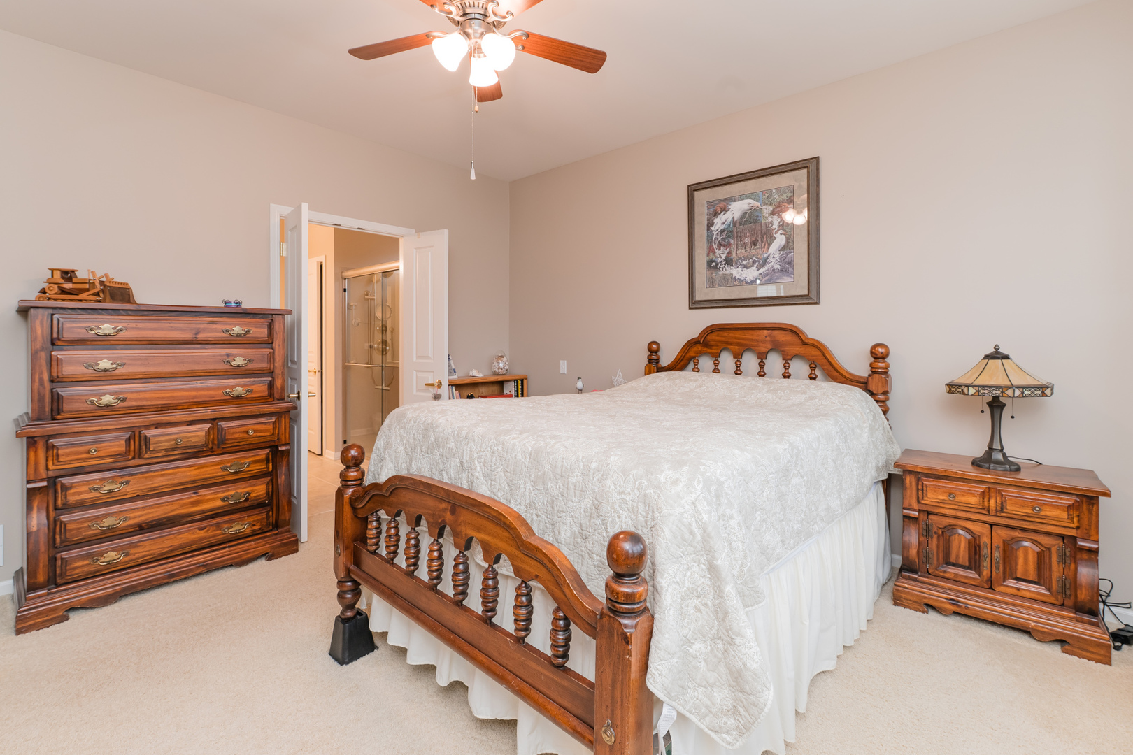 13822 Chestnut Lane Huntley, IL 60142 - Photo 19 of 43 a bedroom with a bed and a chandelier