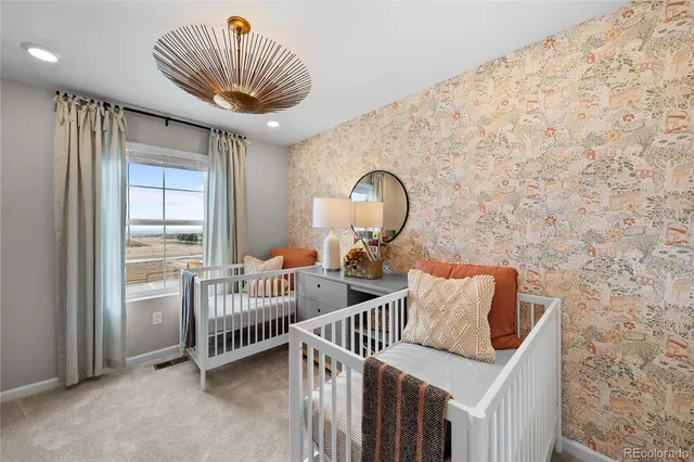 a kitchen with a dining table cabinets appliances and wooden floor