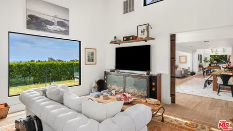 a kitchen with a stove and a flat screen tv