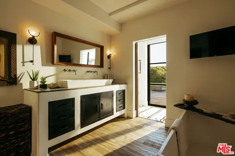 a view of a house with a big yard and large trees