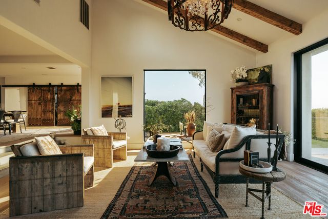a bedroom with a bed and large windows