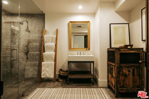 a view of a house with a big yard and large trees