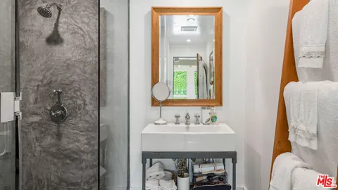 a view of a patio with table and chairs potted plants and a large tree