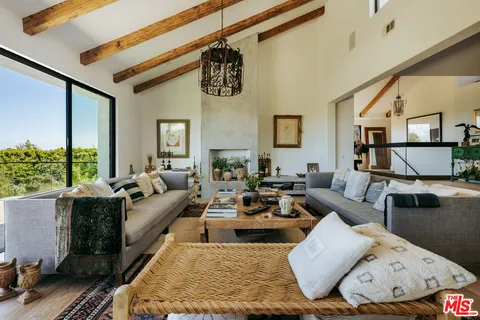a view of living room with furniture and floor to ceiling window