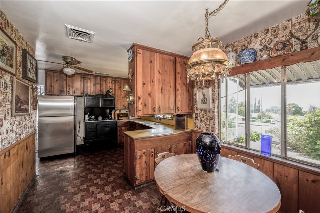 10343 Helendale Avenue Tujunga, CA 91042 - Photo 12 of 30 a kitchen with stainless steel appliances granite countertop a sink a stove and a refrigerator