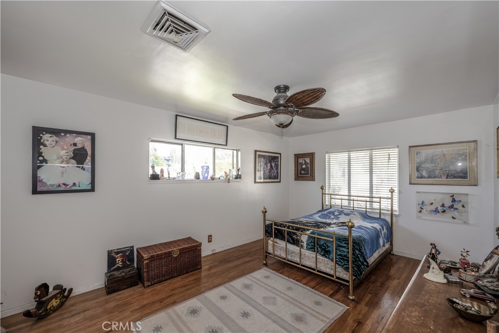 10343 Helendale Avenue Tujunga, CA 91042 - Photo 13 of 30 a bedroom with furniture and a window