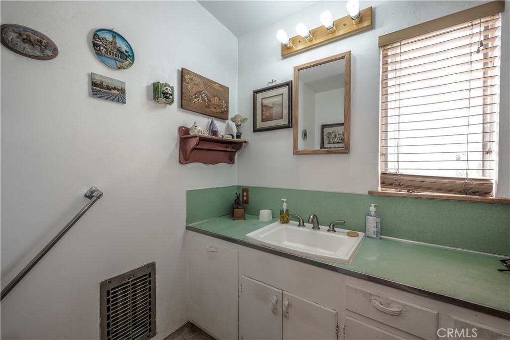 10343 Helendale Avenue Tujunga, CA 91042 - Photo 18 of 30 a bathroom with a sink and a mirror