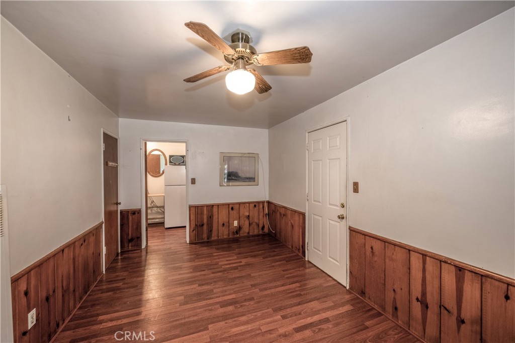 10343 Helendale Avenue Tujunga, CA 91042 - Photo 22 of 30 a view of a hallway with wooden floor and chandelier fan