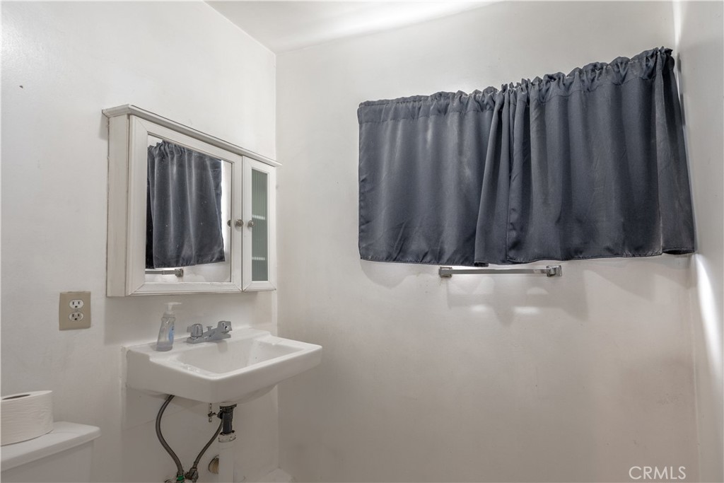 10343 Helendale Avenue Tujunga, CA 91042 - Photo 25 of 30 a bathroom with a sink and a mirror