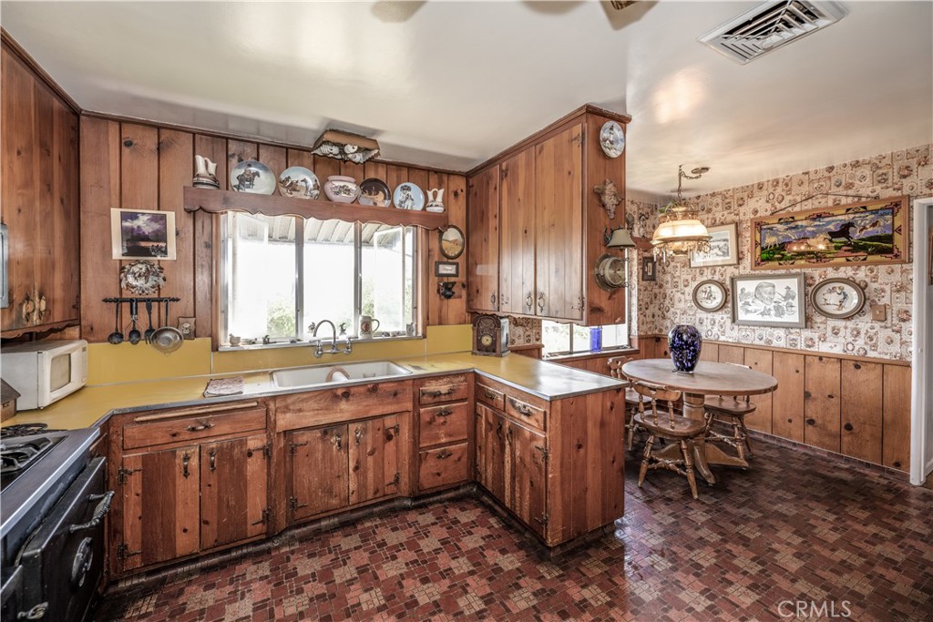 10343 Helendale Avenue Tujunga, CA 91042 - Photo 10 of 30 a large kitchen with lots of counter space and windows