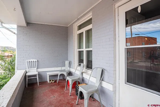 a living room filled with furniture and a floor to ceiling window