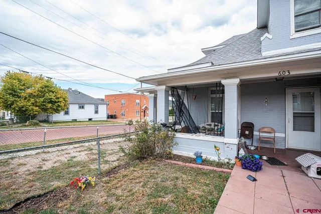 a view of a house with a yard and sitting area