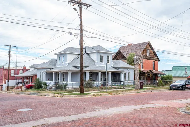 an aerial view of a house with swimming pool and ocean view