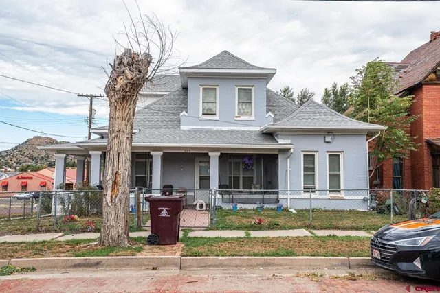 a front view of a house with garden space and porch