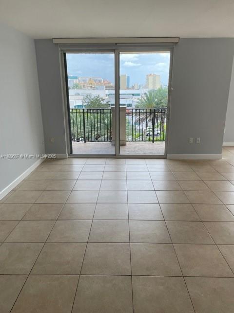 2650 Southwest 37th Avenue, Unit 501 Miami, FL 33134 - Photo 2 of 16 a view of a livingroom with a floor to ceiling window