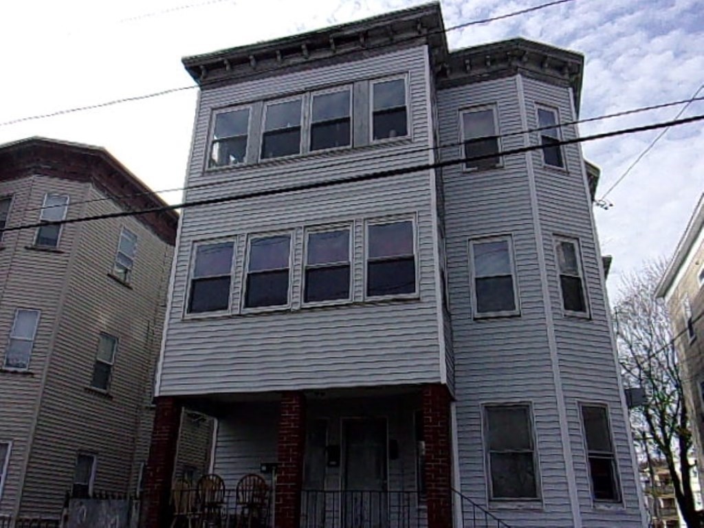 18-20 Conduit Street Lawrence, MA 01841 - Photo 1 of 23 a front view of a house with a balcony