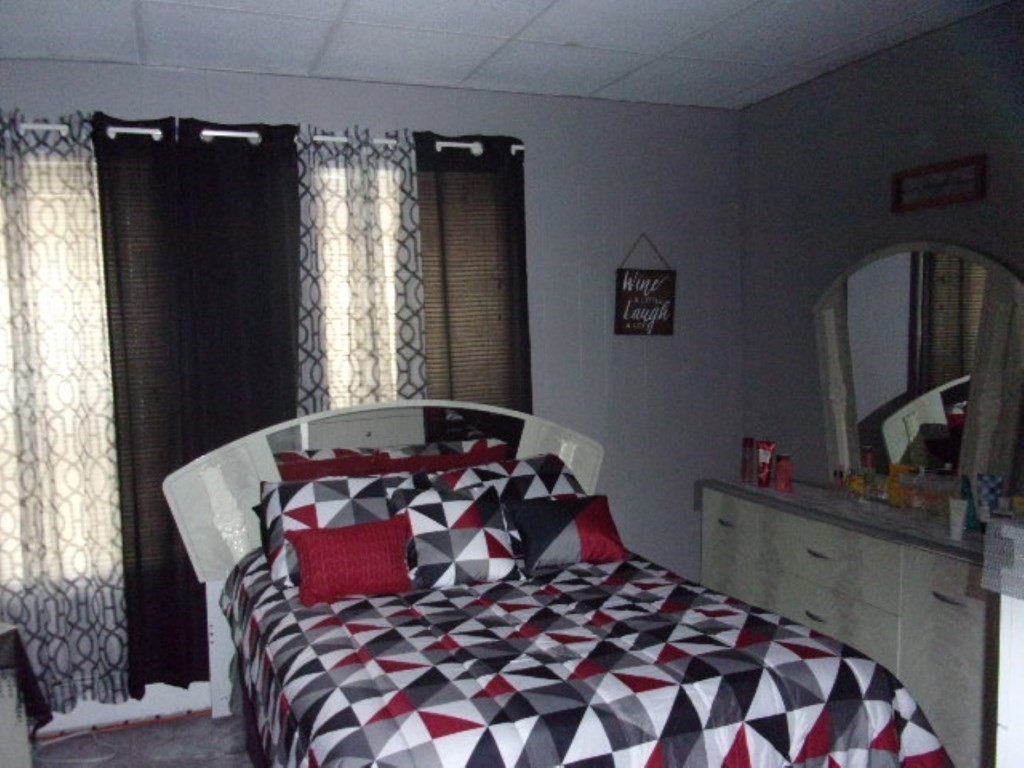 18-20 Conduit Street Lawrence, MA 01841 - Photo 20 of 23 a bedroom with a bed and a window