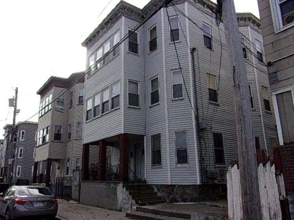 18-20 Conduit Street Lawrence, MA 01841 - Photo 2 of 23 a front view of a building with a yard