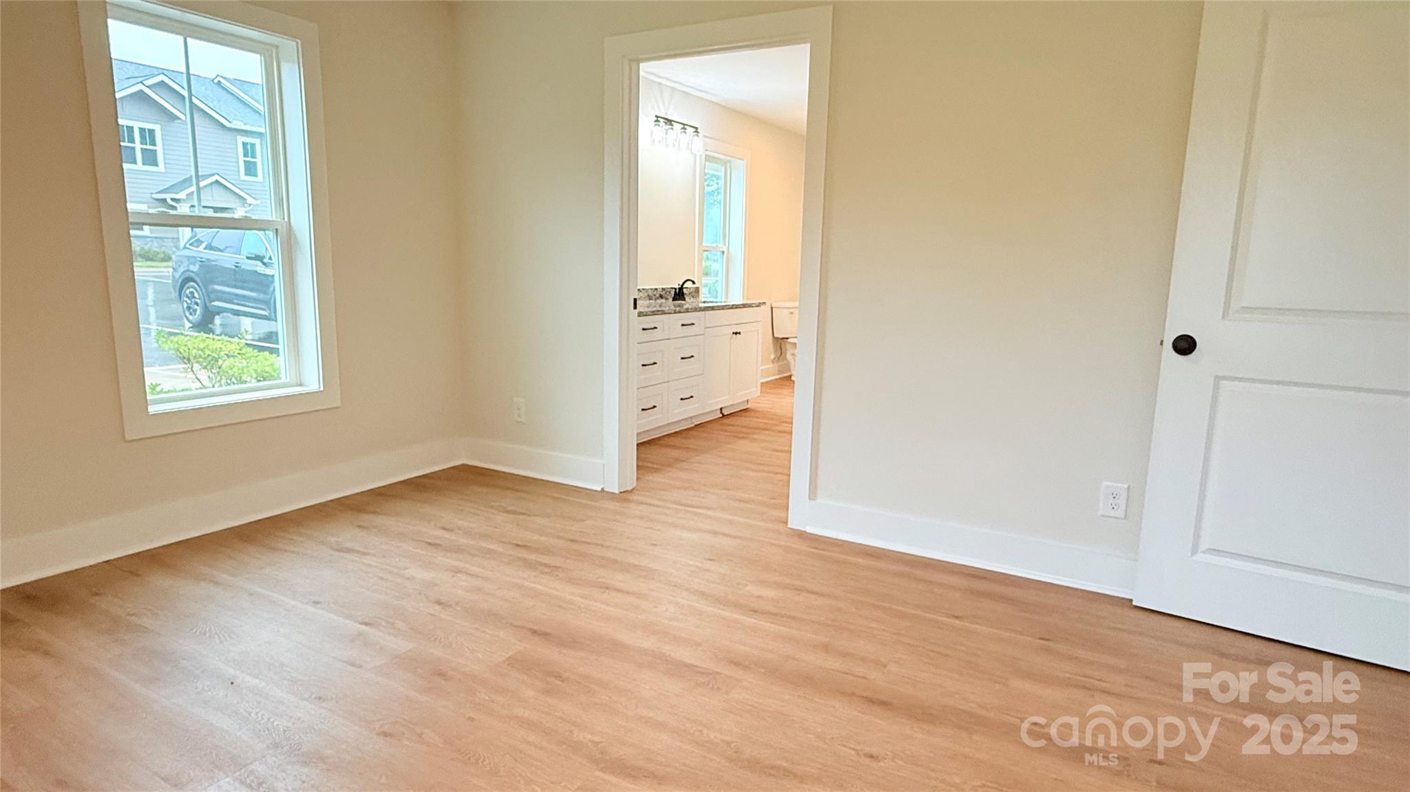 203 Beacon Avenue Morganton, NC 28655 - Photo 11 of 18 an empty room with wooden floor and windows