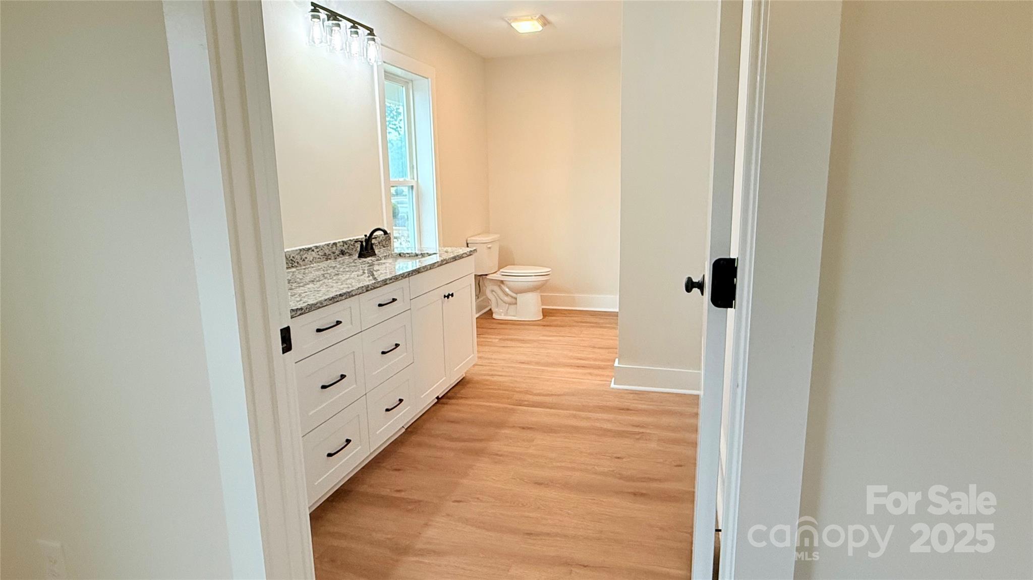 203 Beacon Avenue Morganton, NC 28655 - Photo 12 of 18 a bathroom with a double vanity sink and a mirror