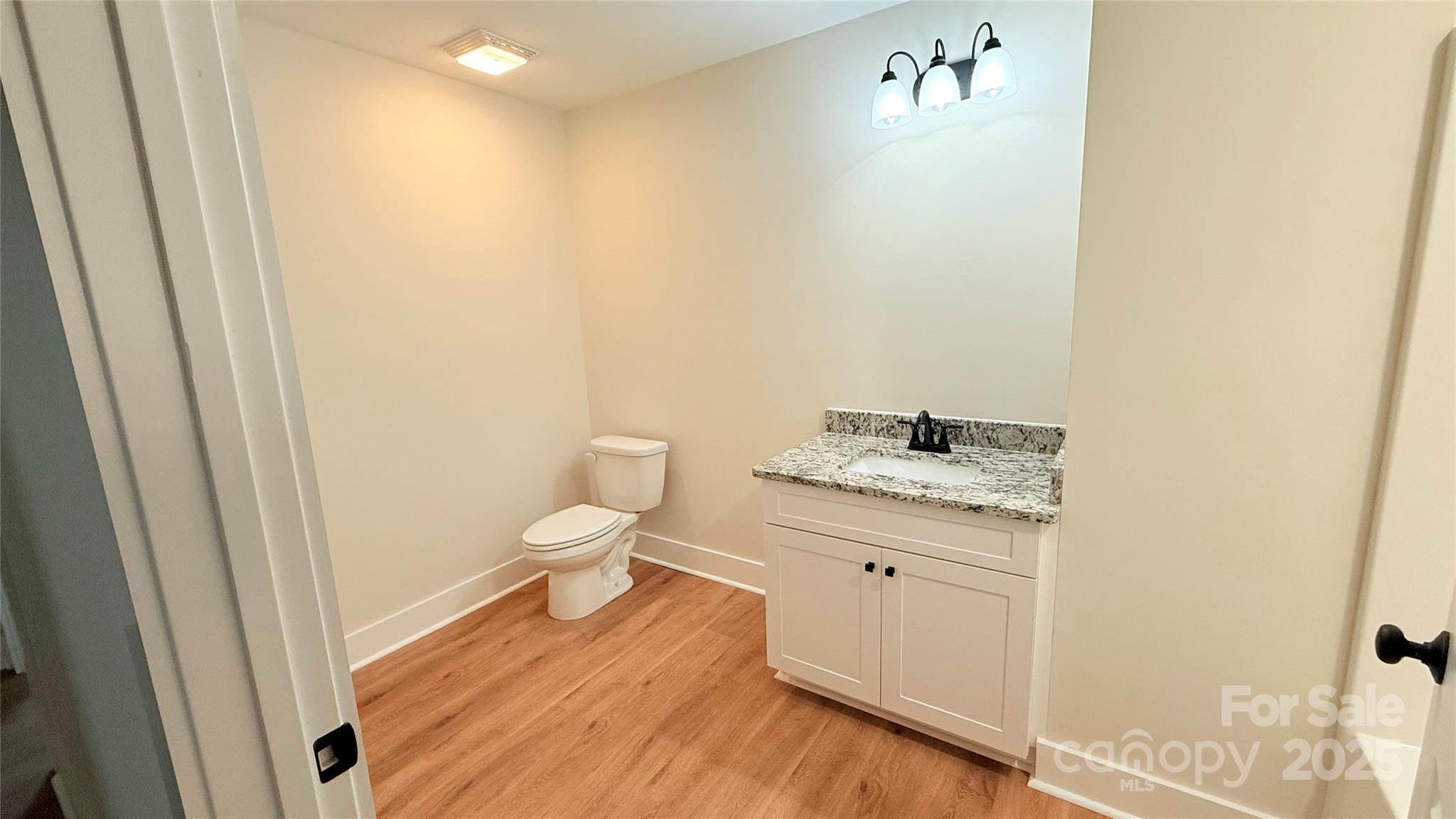 203 Beacon Avenue Morganton, NC 28655 - Photo 15 of 18 a bathroom with a granite countertop toilet and a sink