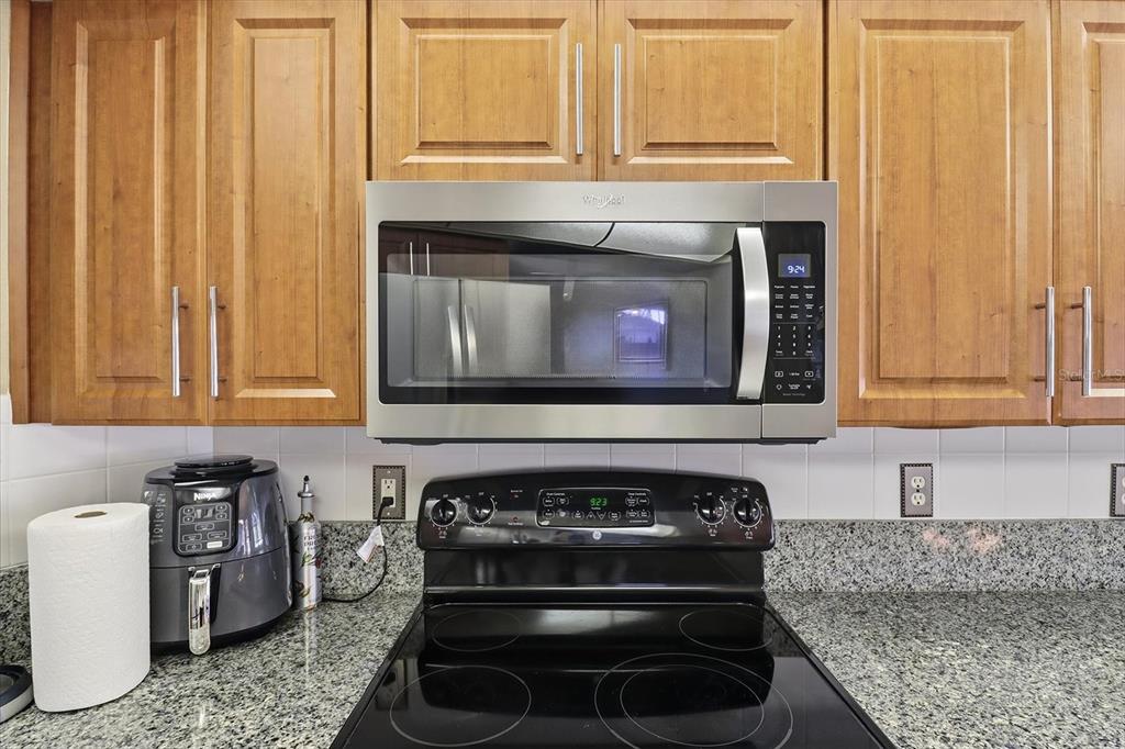 3 Ipomoea Court Homosassa, FL 34446 - Photo 13 of 46 a kitchen with a stove and a microwave
