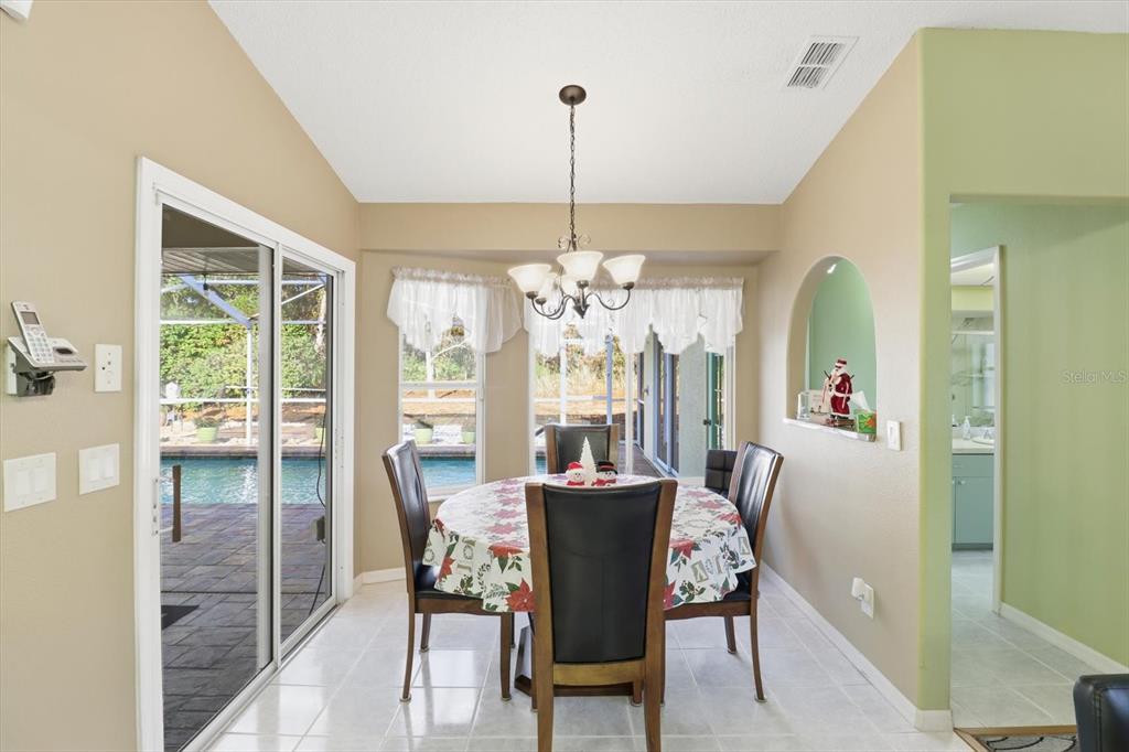 3 Ipomoea Court Homosassa, FL 34446 - Photo 15 of 46 a view of a dining room with furniture window and wooden floor