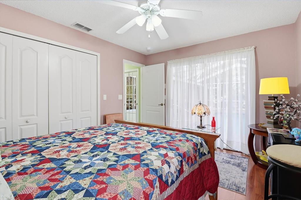 3 Ipomoea Court Homosassa, FL 34446 - Photo 17 of 46 a bedroom with a bed and a chandelier