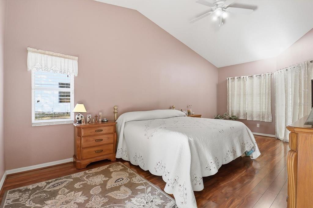 3 Ipomoea Court Homosassa, FL 34446 - Photo 20 of 46 a bedroom with a bed and a chandelier