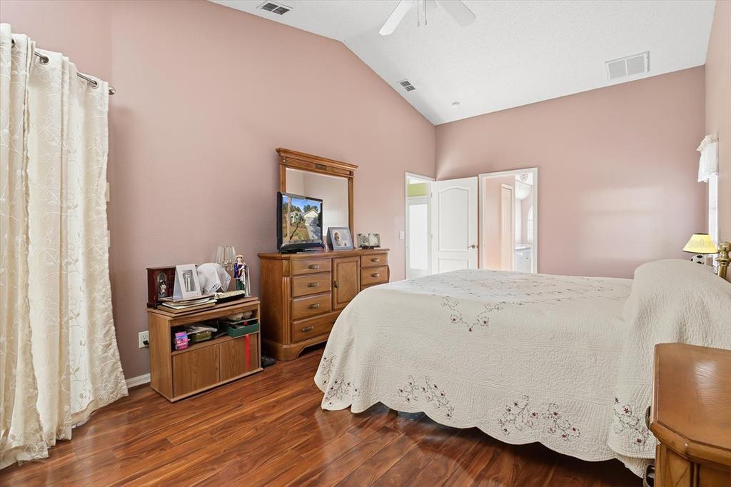 3 Ipomoea Court Homosassa, FL 34446 - Photo 21 of 46 a spacious bedroom with a bed and wooden floor