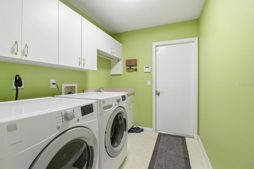 3 Ipomoea Court Homosassa, FL 34446 - Photo 27 of 46 a utility room with dryer and washer