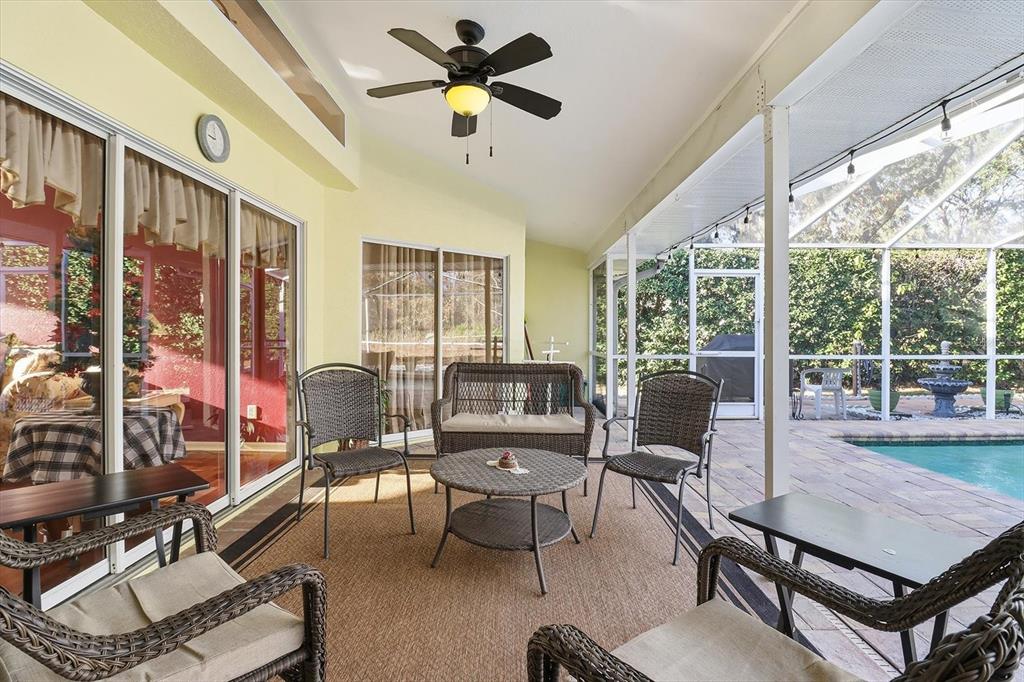 3 Ipomoea Court Homosassa, FL 34446 - Photo 30 of 46 a living room with furniture a ceiling fan and a large window