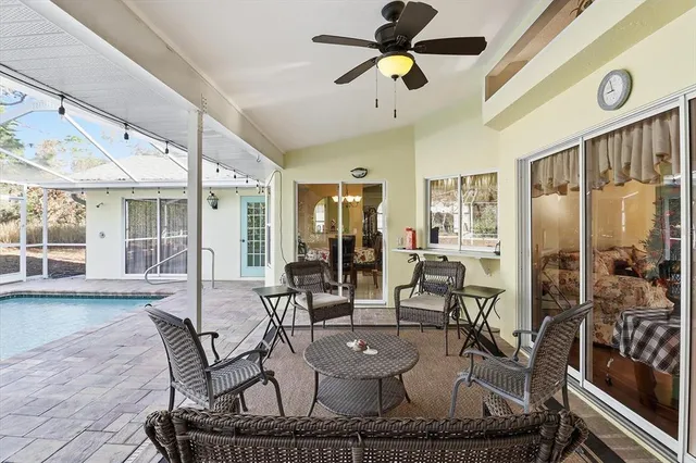a view of a swimming pool with a patio and a yard