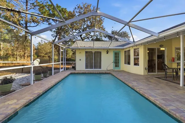 a view of a swimming pool with a patio