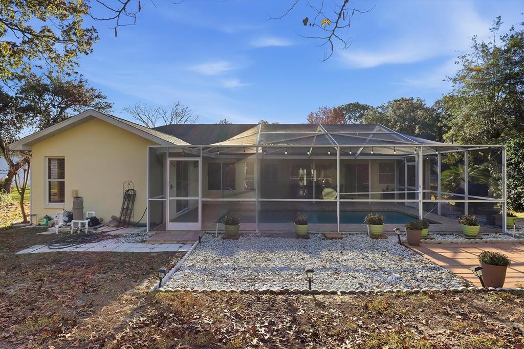 3 Ipomoea Court Homosassa, FL 34446 - Photo 38 of 46 a view of a house with a yard and sitting area
