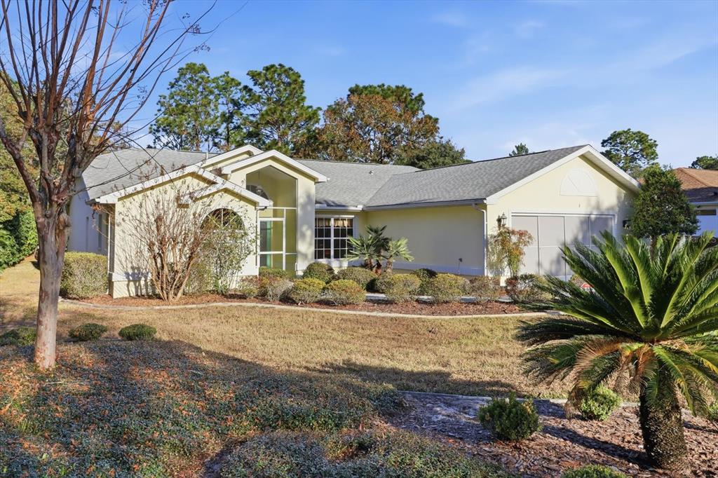 3 Ipomoea Court Homosassa, FL 34446 - Photo 40 of 46 a front view of a house with a yard and garage