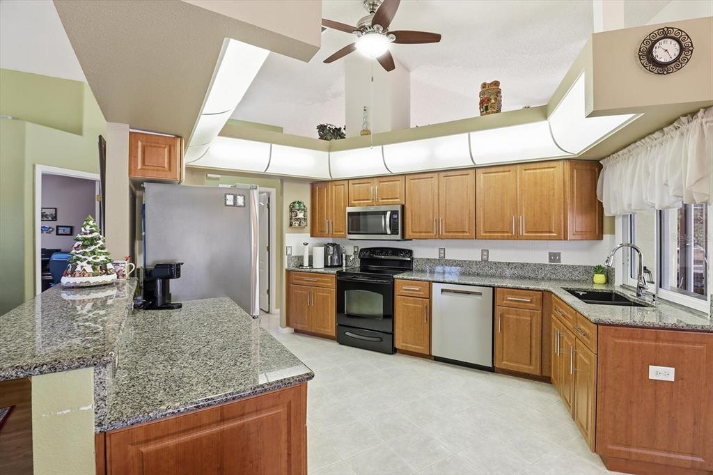 3 Ipomoea Court Homosassa, FL 34446 - Photo 10 of 46 a kitchen with stainless steel appliances granite countertop a sink a stove and cabinets