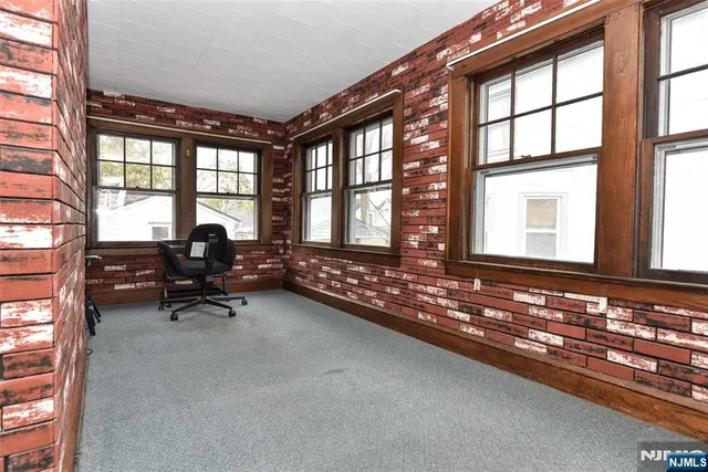 a living room with furniture and floor to ceiling windows