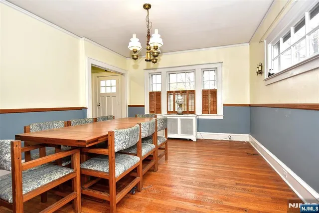 a view of a dining room with furniture and a chandelier