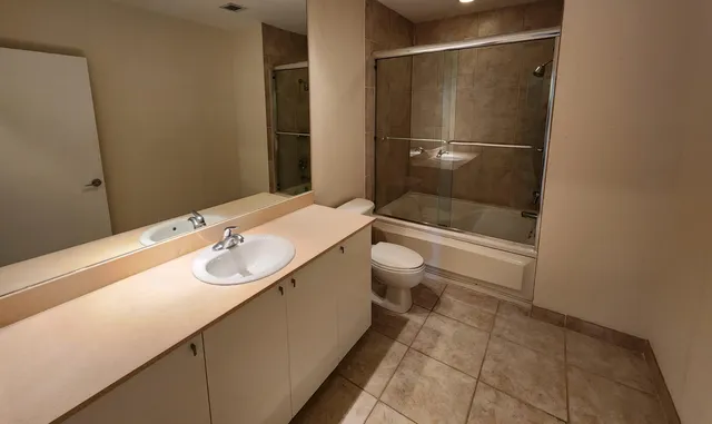 a bathroom with a sink and mirror with toilet