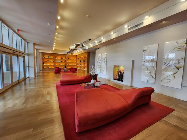a bedroom with a large bed and a flat tv screen on dresser