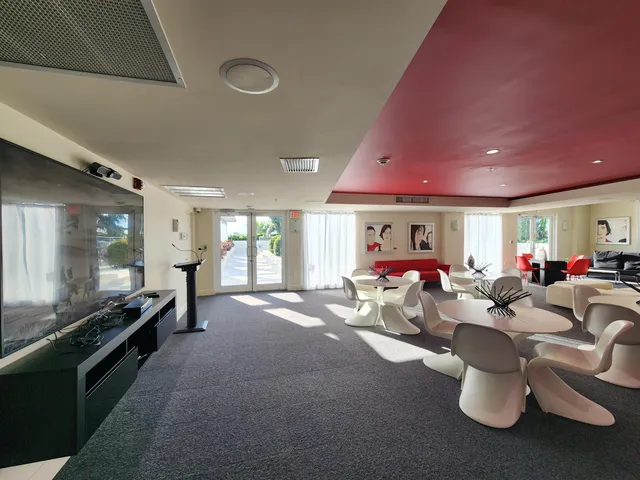 a living room with furniture a window and flat screen tv